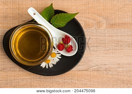 A Cup Of Honey On The Plate. The Honey In The Spoon Drops, Raspberry, Chamomile, Derevyanny Backgrou