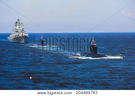 A line of modern russian military submarine cruisers in the row, northern fleet and baltic sea fleet in the open sea, submarine