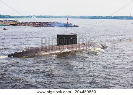 A line of modern russian military submarine cruisers in the row, northern fleet and baltic sea fleet in the open sea, submarine