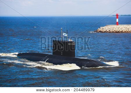 A line of modern russian military submarine cruisers in the row, northern fleet and baltic sea fleet in the open sea, submarine