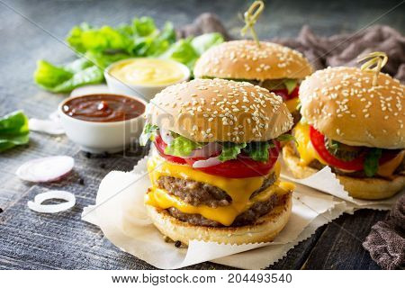 Delicious Fresh Homemade Double Cheeseburger On A Wooden Kitchen Table. Double Burger With Meat Cutl