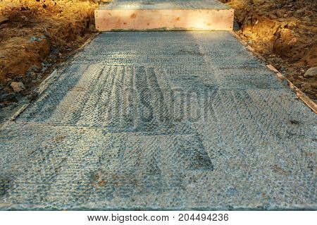 Concrete Construction Contractor Installing A Sidewalk, Curb And Storm Drainage Gutter