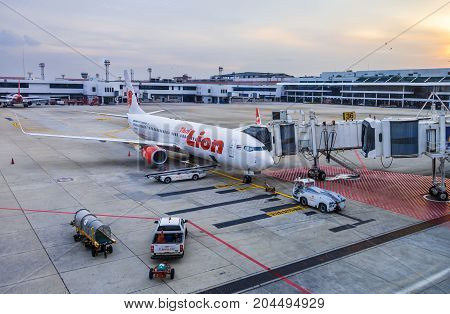 Bangkok Thailand - 14 September 2017 - Thai Lion Air aircraft waits for passengers while technician checks on the engine at Don Muang International Airport Bangkok Thailand on September 14 2017