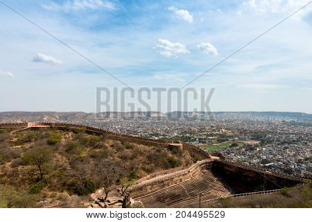 Horizontal picture of city view and the long wall of Nahargarh Fort in Jaipur known as pink city in India.