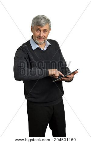 Mature man using computer tablet. Senior entrepreneur working on digital computer tablet with index finger on white background.
