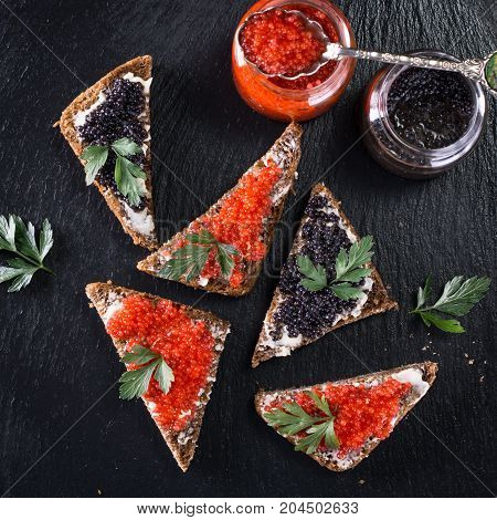 Red And Black Caviar In Small Silver Spoon On A Wood Background With Black Bread ,food Concept