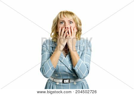 Shocked and horrified mature woman. Surprised white-skin woman covering mouth with hands on white background. Human facial expressions and emotions.