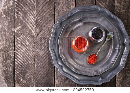 Red And Black Caviar In Small Silver Spoon On A Wood Background With Black Bread ,food Concept