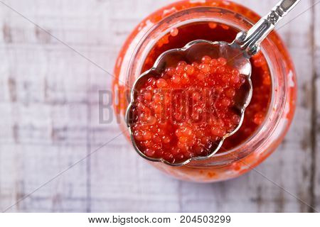 Red And Black Caviar In Small Silver Spoon On A Wood Background With Black Bread ,food Concept