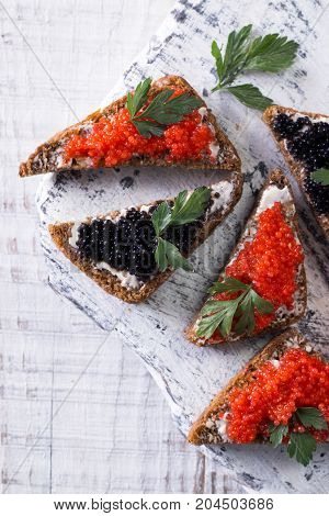 Red And Black Caviar In Small Silver Spoon On A Wood Background With Black Bread ,food Concept