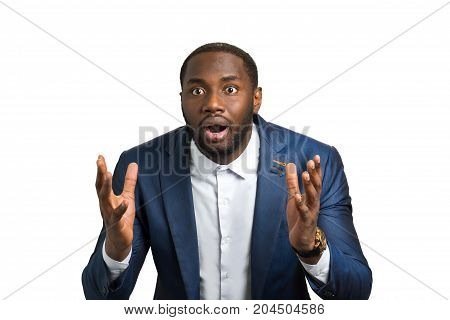 Surprised businessman on white background. Afro american man with feelings of amazement and curiosity.