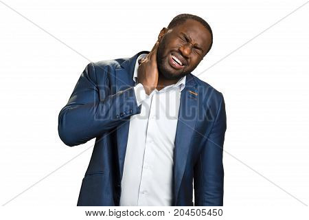 Man with closed eyes and neckache. Handsome unhappy businessman has pain in neck. Painful feelings in neck in young manager.