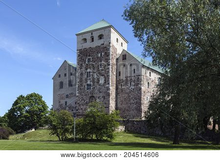 TURKU, FINLAND ON JUNE 30. Outdoor view of the Turku Medieval Castle from the 13th century on June 30, 2017 in Turku, Finland. Classical stone building. Editorial use.