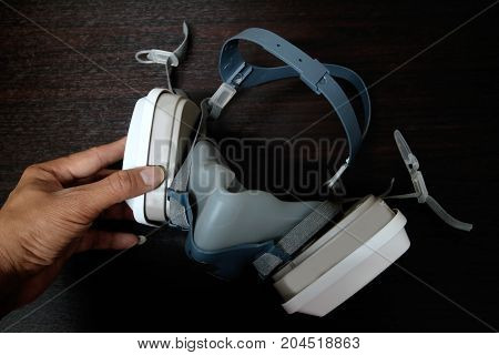 Multi-purpose respirator half mask for toxic gas protection.The man prepare to wear Multi-purpose respirator half mask.