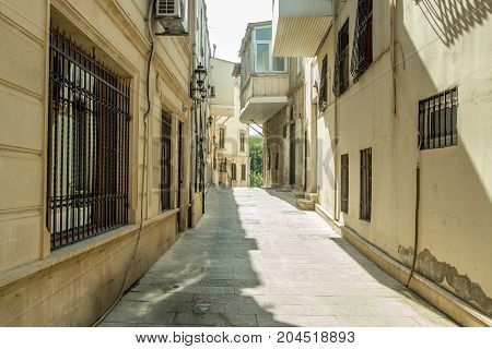 Narrow old classic empty street in Old City of Baku - Icheri Sheher. Historical core of Baku