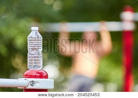 Training tools. Young strong man train his muscles on training outside onb the background. Active life and sport concept.
