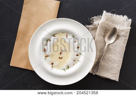 Delicious cream soup with honey fungus top view. Gourmet meal with mushrooms and crusty bread, restaurant serving