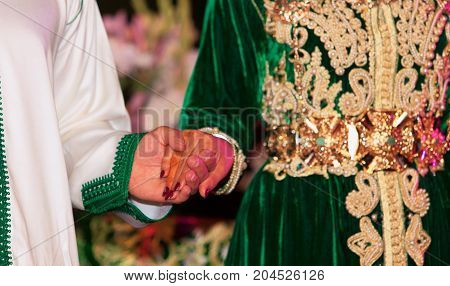 Close up of moroccon couple's hands at a wedding concept of marriage moroccan wedding