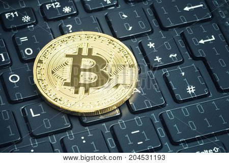 golden bitcoin on the laptop keyboard with degital background around.