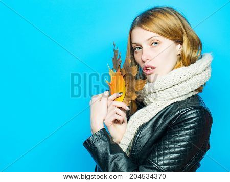 Woman With Autumn Leaves In Leather Jacket And Scarf