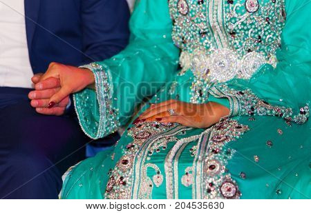 Close up of moroccon couple's hands at a wedding concept of marriage moroccan wedding