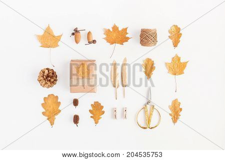 Autumn composition. Gift autumn golden leaves pine cones accessories on white background. Flat lay top view