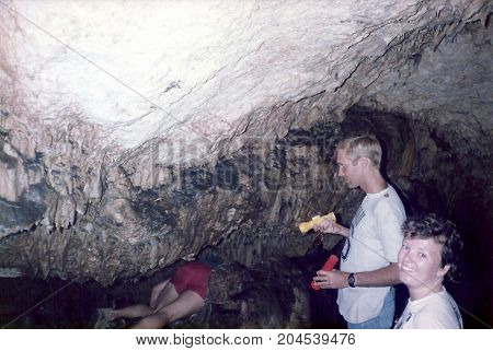 TONGATAPU / TONGA - CIRCA 1990: Spelunkers explore a limestone cave on the east side of the island of Tongatapu.