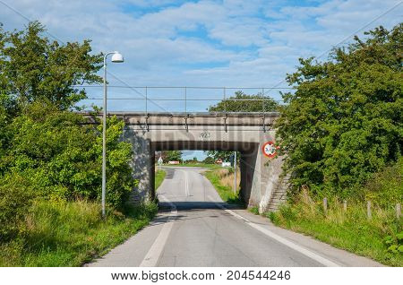 Bridge leads the railway above the road near town of Vordingborg in Denmark