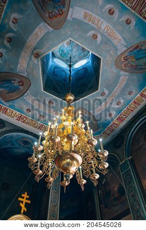 Dnipro Ukraine - August 06 2017: Church of St. Nicholas large gold or bronze chandelier in the temple or cathedral big bronze with handelier in the church orthodox church inside