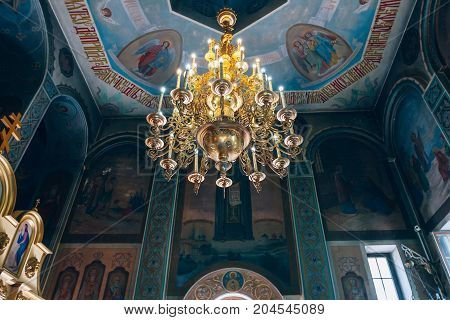 Dnipro Ukraine - August 06 2017: Church of St. Nicholas large gold or bronze chandelier in the temple or cathedral big bronze with handelier in the church orthodox church inside
