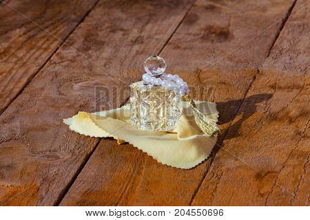 perfume bottle and pearls on a wooden background.pearl braclet. perfume