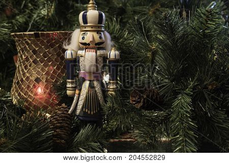 Christmas decoration background with red candle holder and nutcracker surrounded by greenery