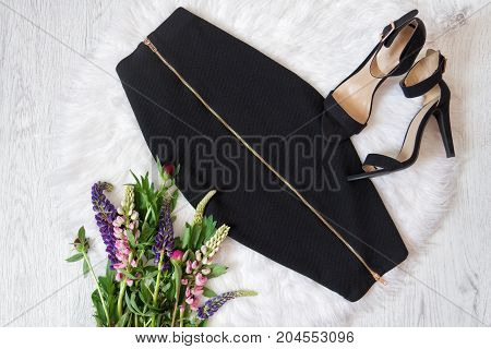 Midi Black Skirt With A Zipper And Shoes With White Fur, A Bouquet Of Flowers. Fashionable Concept