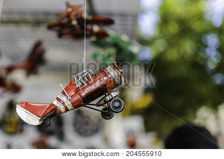 Scale model of old airplane hanging from a rope in a stall in El Rastro de Madrid