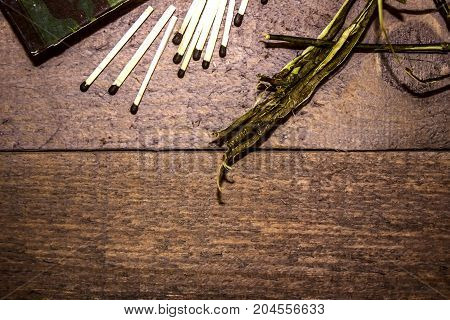 Boxes matches tree bark - for ignition of fire on a dark wooden background. Set for a hike.