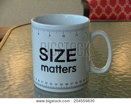 a size matters coffee cup with ruler