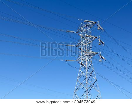 Industrial Power Lines Tower in Front of a Blue Sky