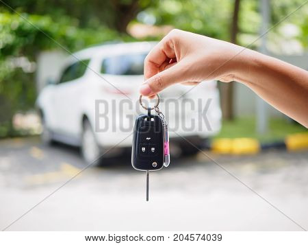 Hand holding the remote control car alarm systems.