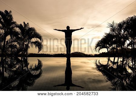 silhouette man open arms or rood shape standing alone