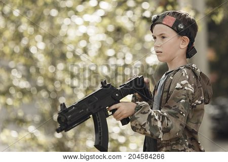 Young Boy In Camouflage With A Gun, Lasertag