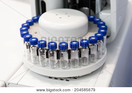 A cassette with glass test tubes, a fragment of gas chromatograph equipment. Research equipment.
