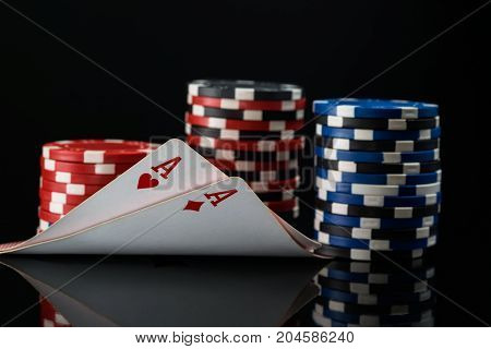 Two red aces in poker cards against the background of poker stakes