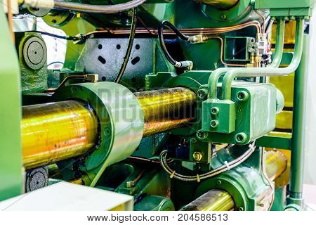 Fragment of the injection molding machine. Abstract industrial background.
