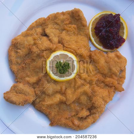 Authentic Schnitzel Wiener Art or Wiener Schnitzel vom Schwein (Pork) Served at as Restaurant in Innsbruck, Austria