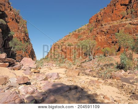 Dry Ormiston Gorge with red glowing cliffs in the evening sun Northern Territory Australia 2017