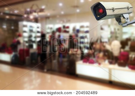 CCTV security indoor camera system operating trendy bag shop in department store shopping mall fashion shopping surveillance security and safety technology concept