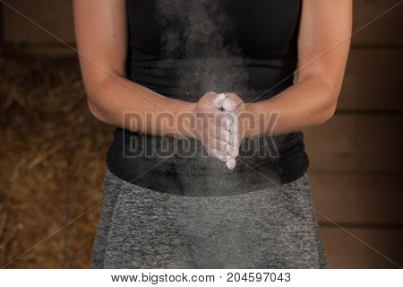 Active Young Fit Woman Claping Hands With Magnesium On Them Before Lifting Barbell Weights