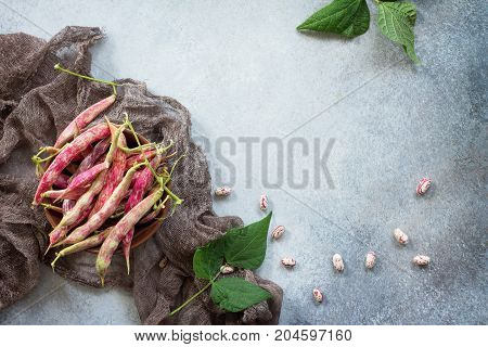 Green Bean Pod And Beans. Red Beans On A Gray Slate Or Stone Background. Top View With Copy Space.