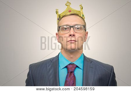 Smug boss. VIP client. Premium user concept. Success. Business man in suit with golden crown above head.