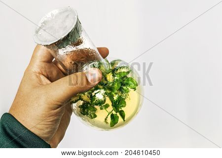 Man's hand with a test tube with microplant, research gmo microbiology concept